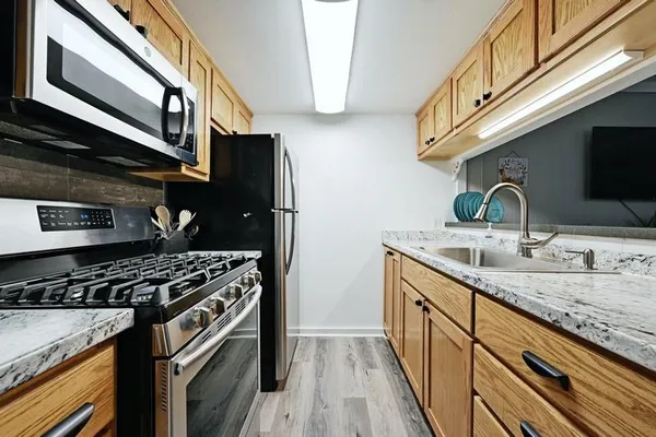 a kitchen with stainless steel appliances granite countertop a stove and a sink