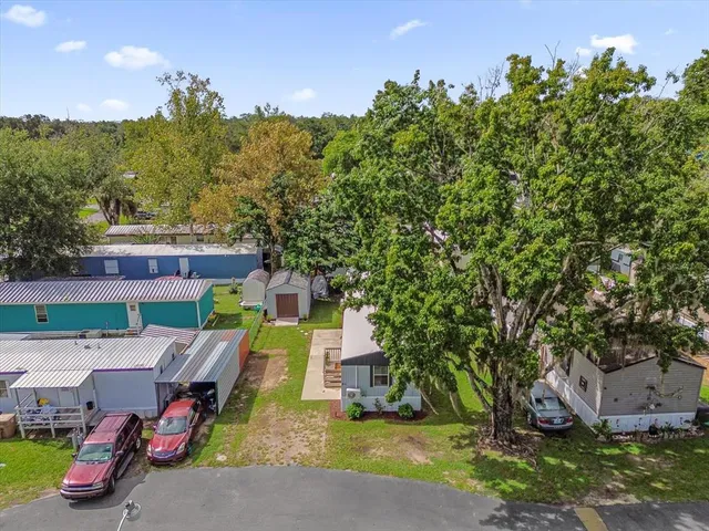 an aerial view of a house with garden space and street view