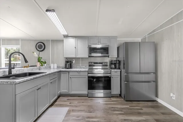 a kitchen with a sink appliances and cabinets