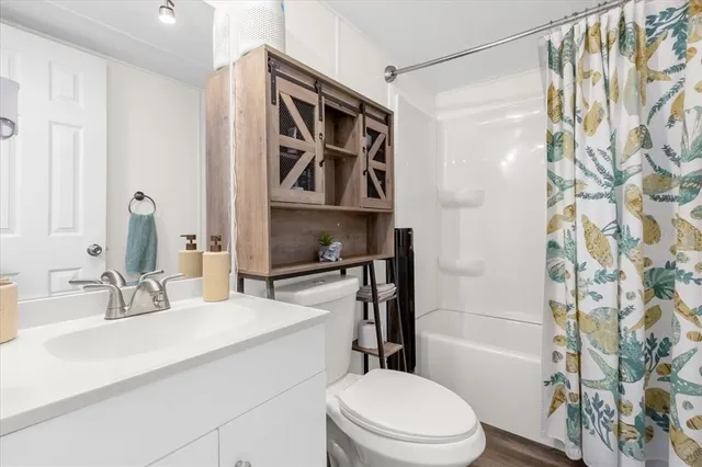 a bathroom with a sink toilet and shower