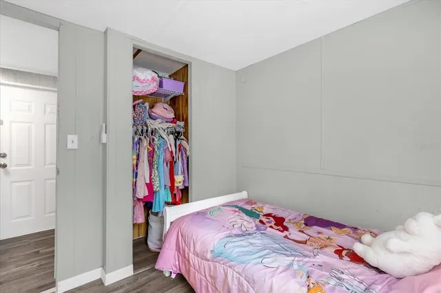 a bedroom with a bed and a closet