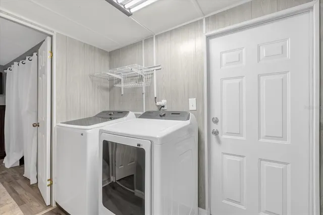 a utility room with cabinets washer and dryer