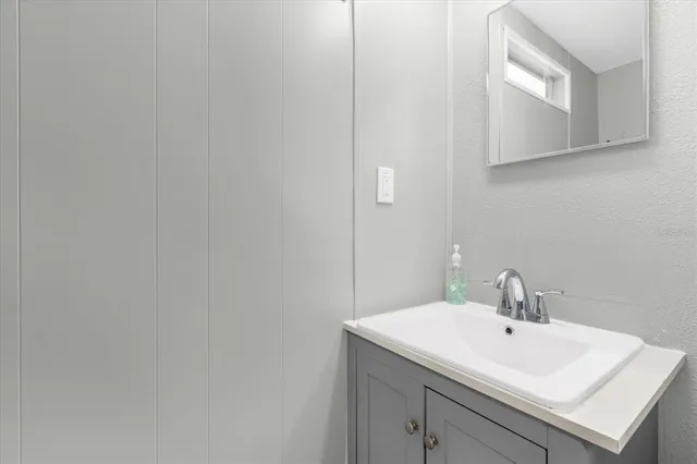 a bathroom with a sink and a mirror