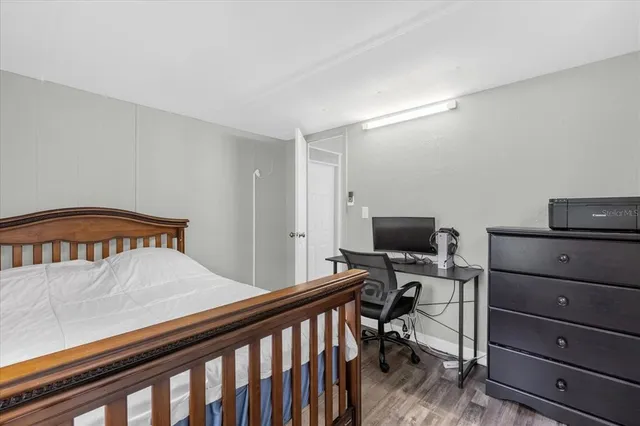 a bedroom with a bed and a tv on the dresser