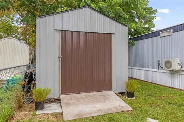 a view of backyard with potted plants and wooden fence