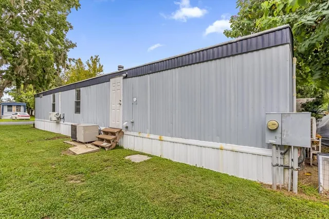 a view of a backyard with plants and a bench