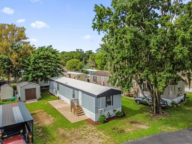an aerial view of a house with a big yard