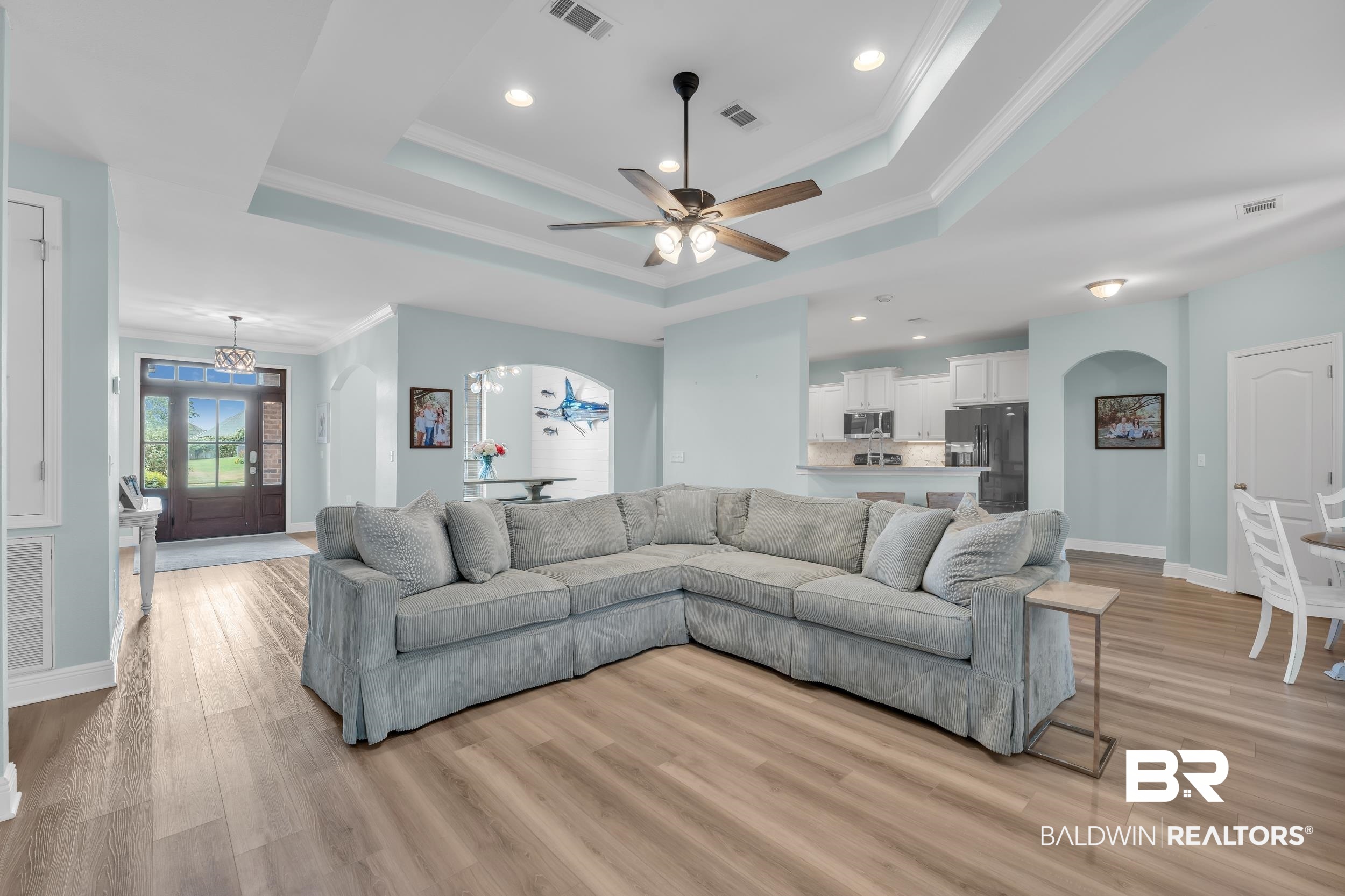 7109 Rocky Rd Loop Gulf Shores, AL 36542 - Photo 11 of 30 Living area featuring light wood-style floors, a tray ceiling, and visible vents