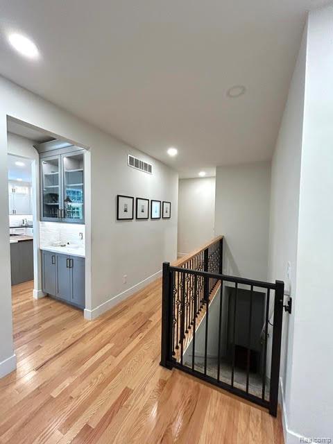 39 Stark Road Rochester, MI 48307 - Photo 29 of 70 View of great room looking down hall to butlers pantry, 2 separate bedrooms, 3rd full bath and stairs to lower level walk out finished basement
