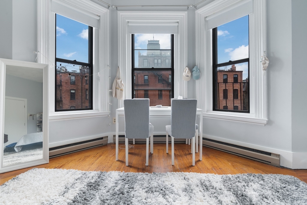 389 Beacon Street, Unit 8 Boston, MA 02116 - Photo 2 of 9 a view of a dining room with furniture window and wooden floor