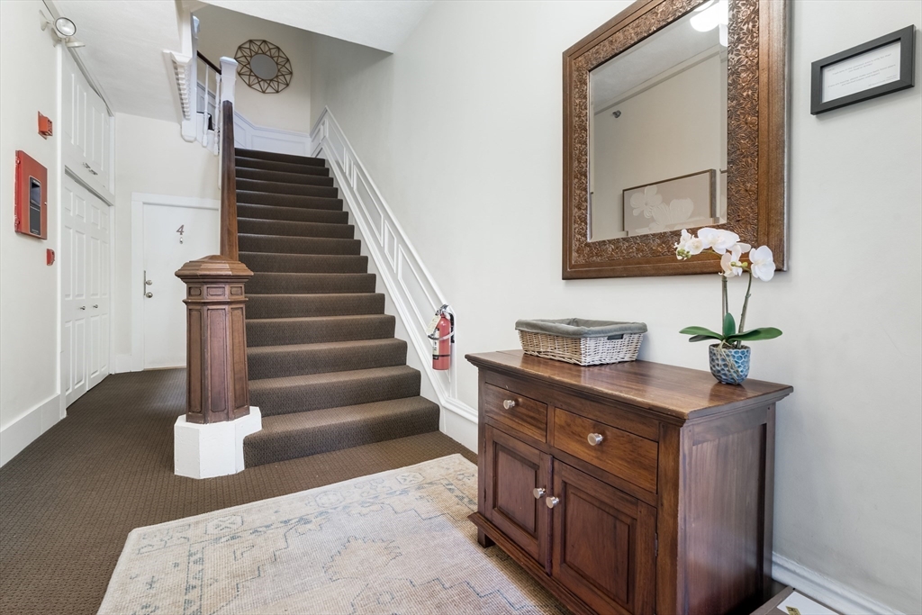 389 Beacon Street, Unit 8 Boston, MA 02116 - Photo 7 of 9 a view of hallway with a sink and a mirror
