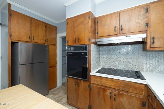 a kitchen with stainless steel appliances granite countertop a refrigerator and a stove
