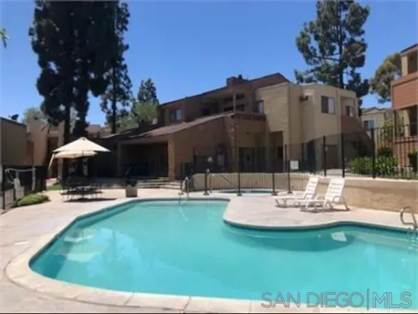 a view of a house with swimming pool and sitting area