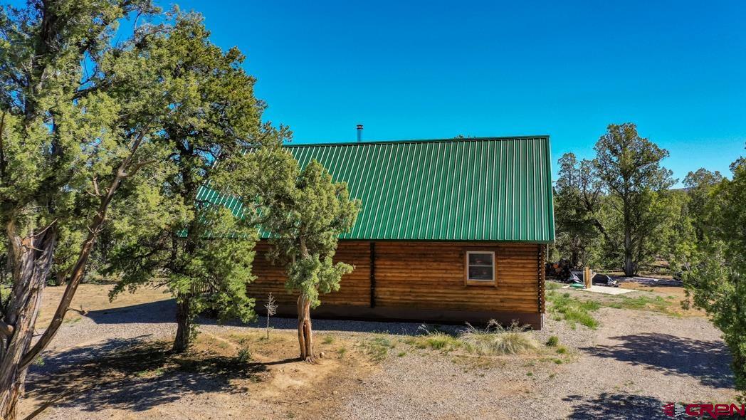 553 Cow Canyon Road Ignacio, CO 81137 - Photo 3 of 34 a front view of a house with a garden
