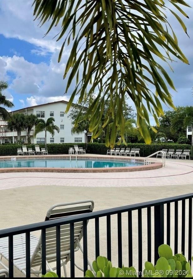 84 Brighton B, Unit 84 Boca Raton, FL 33434 - Photo 22 of 28 a view of a swimming pool and a chairs