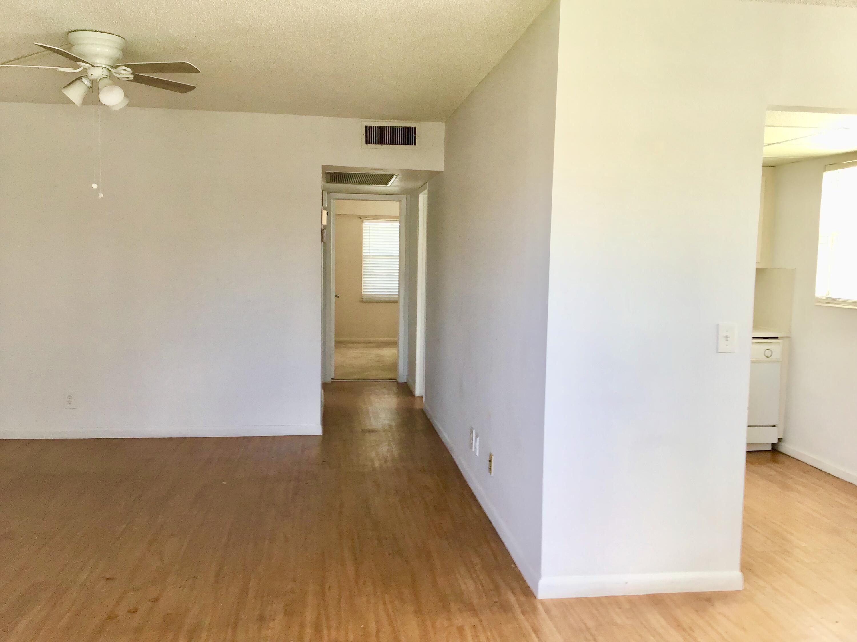 84 Brighton B, Unit 84 Boca Raton, FL 33434 - Photo 5 of 28 a view of a hallway with wooden floor