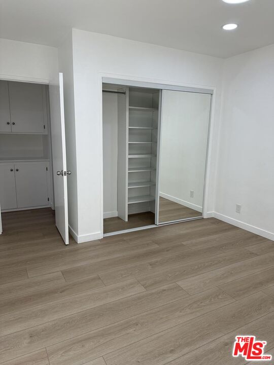 12610 Caswell Avenue, Unit 4 Los Angeles, CA 90066 - Photo 11 of 16 a view of an empty room with wooden floor and closet