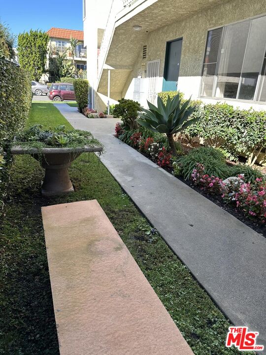 12610 Caswell Avenue, Unit 4 Los Angeles, CA 90066 - Photo 15 of 16 a front view of a house with a yard and potted plants