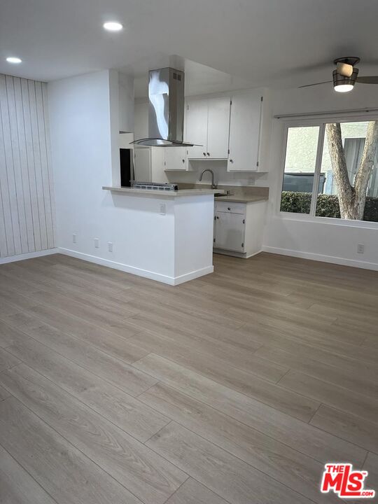 12610 Caswell Avenue, Unit 4 Los Angeles, CA 90066 - Photo 2 of 16 a kitchen with stainless steel appliances a stove top oven a sink and a wooden floors