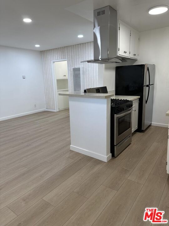 12610 Caswell Avenue, Unit 4 Los Angeles, CA 90066 - Photo 4 of 16 a kitchen with granite countertop a stove and a refrigerator