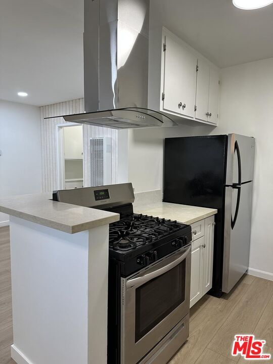 12610 Caswell Avenue, Unit 4 Los Angeles, CA 90066 - Photo 5 of 16 a kitchen with stainless steel appliances granite countertop a stove and a microwave