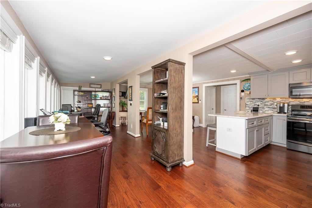 2113 Warf Road Lexington, NC 27292 - Photo 31 of 50 We use this area for our desks but most would make it a dining area. Large shelving on the far wall remains