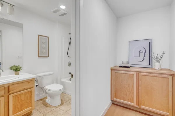 a white toilet sitting next to a bathroom sink
