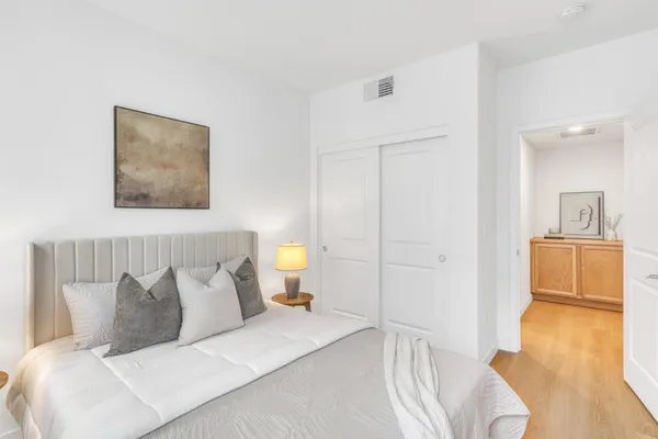 a bedroom with a bed and a couch