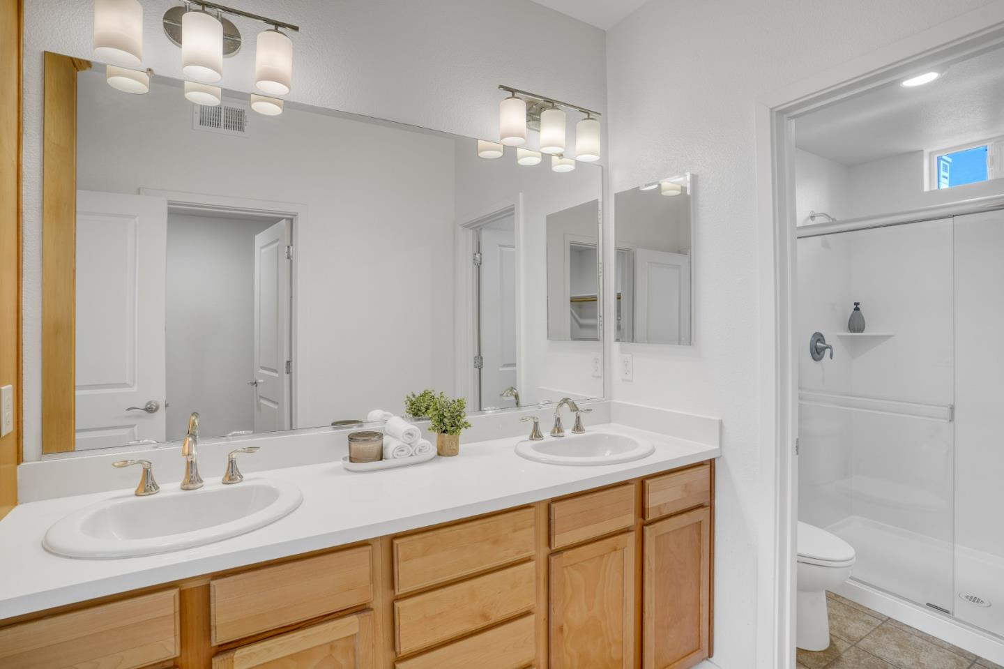 1425 Lavender Loop Milpitas, CA 95035 - Photo 30 of 59 a bathroom with double vanity sink a toilet a shower and a mirror
