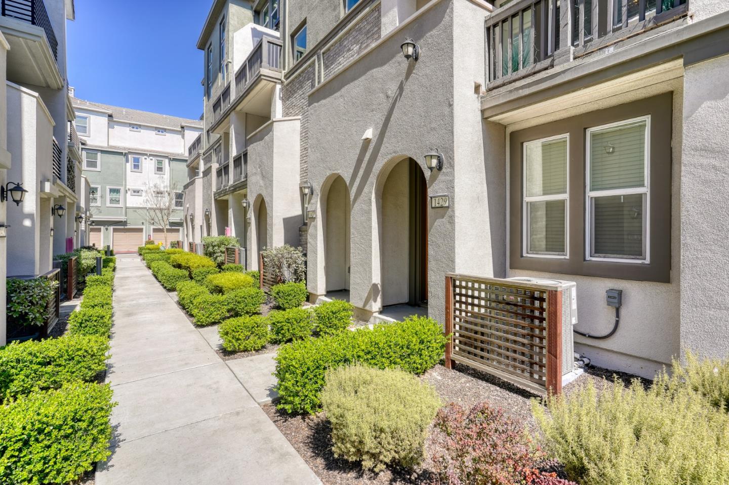 1425 Lavender Loop Milpitas, CA 95035 - Photo 4 of 59 a view of a house with brick walls and flower plants