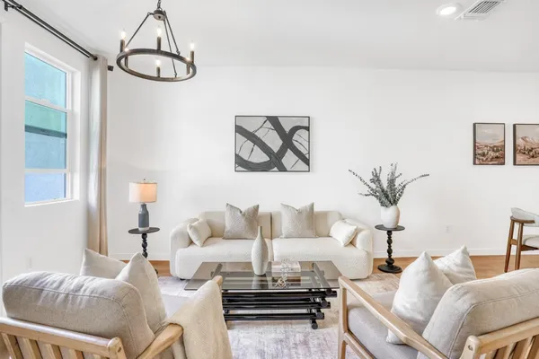 a living room with furniture and a chandelier