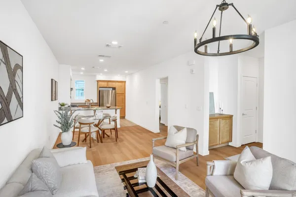 a living room with furniture a window and kitchen view