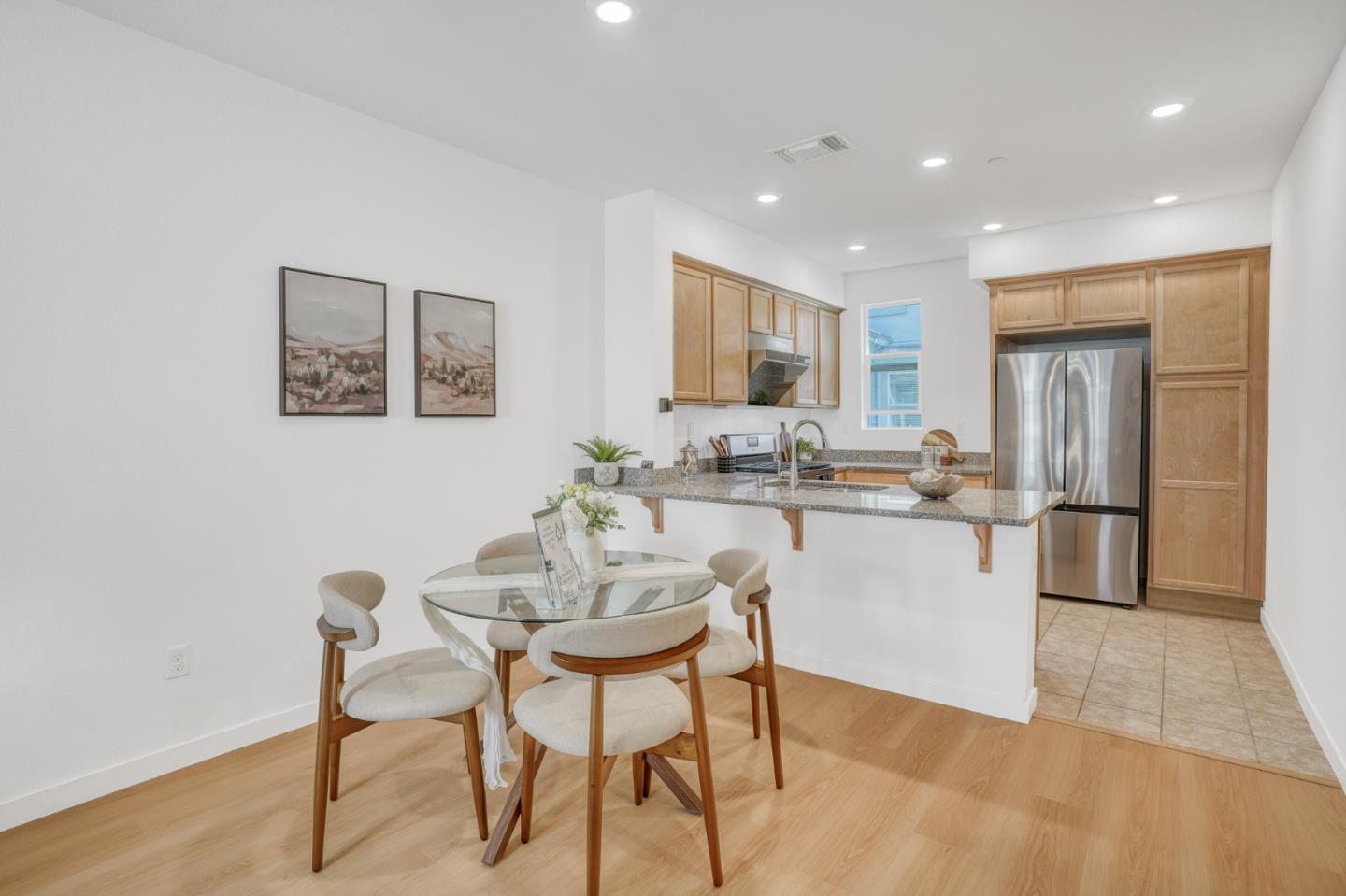 1425 Lavender Loop Milpitas, CA 95035 - Photo 10 of 59 a kitchen with a dining table chairs refrigerator and microwave