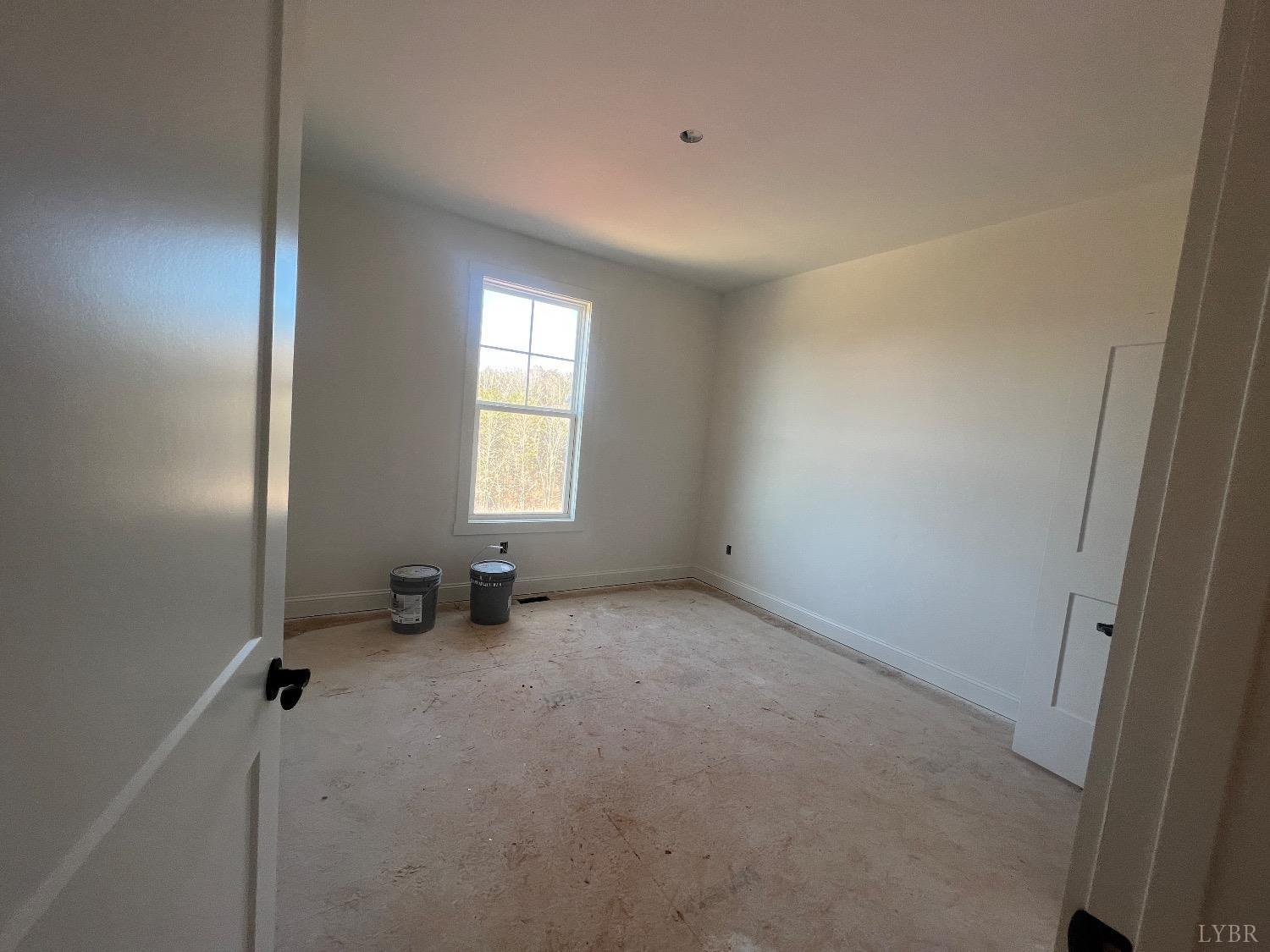 4 Goode Road Goode, VA 24556 - Photo 5 of 15 an empty room with windows and wooden door
