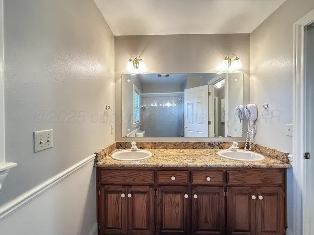 a bathroom with a sink double vanity and a mirror