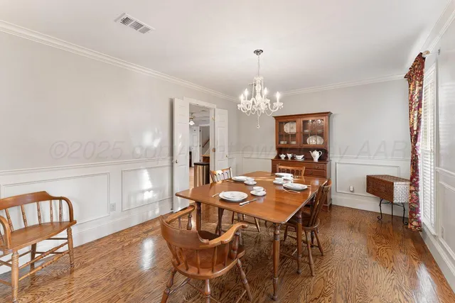 a view of a dining room with furniture and chandelier