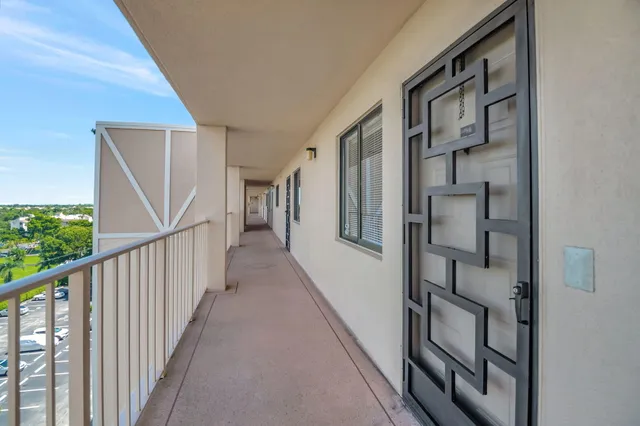 a spacious bedroom with a bed couch and windows