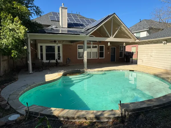 a view of a house with a yard patio and fire pit