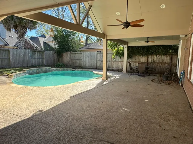 a view of a backyard with wooden fence