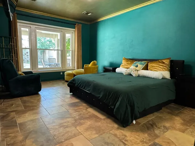 a bedroom with a bed and a couch