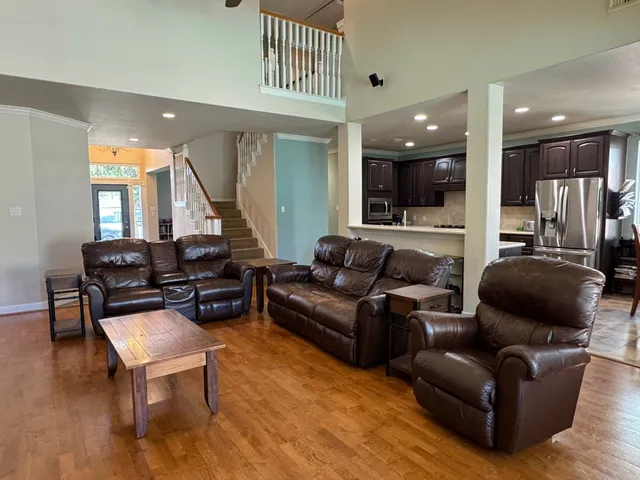 a living room with furniture and a wooden floor