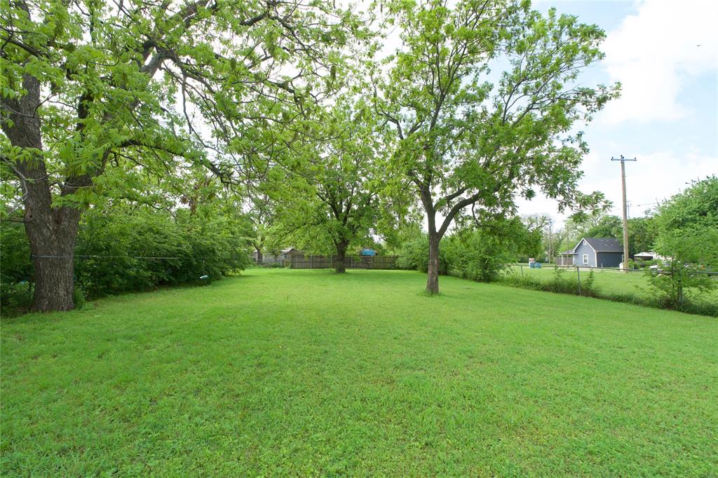 714 Potter Street Gainesville, TX 76240 - Photo 8 of 12 The property offers a generous expanse of green lawn, complemented by several mature trees