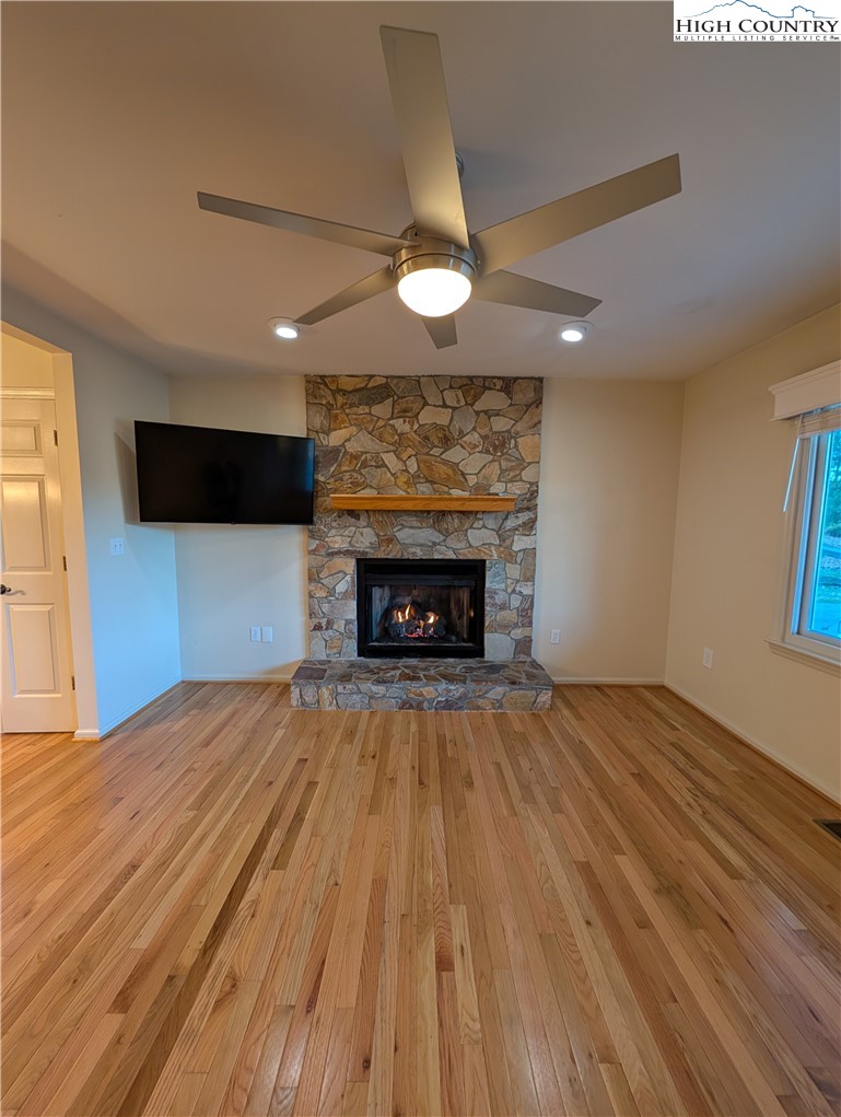 57 Village Road Glade Valley, NC 28627 - Photo 18 of 47 a view of an empty room with a fireplace and a window