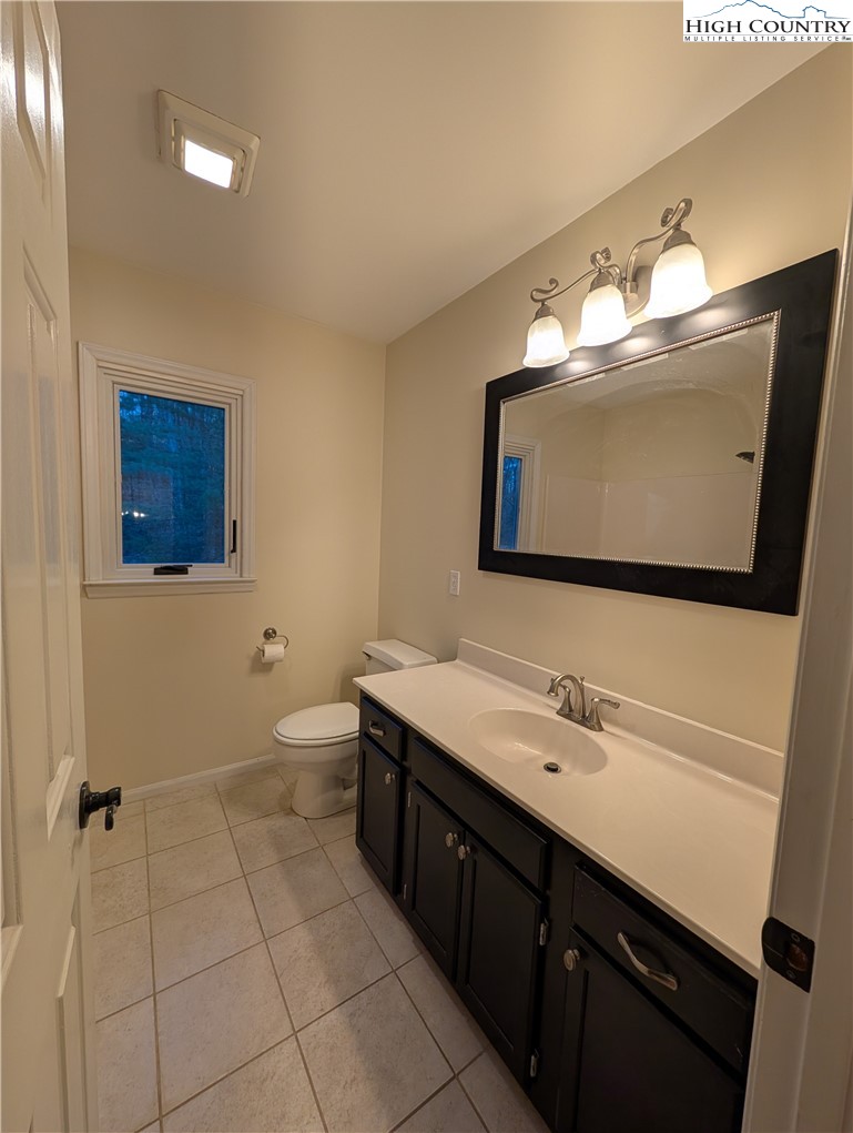 57 Village Road Glade Valley, NC 28627 - Photo 22 of 47 a bathroom with a double vanity sink mirror and bathtub