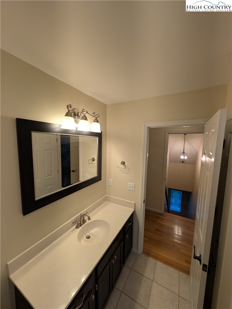 57 Village Road Glade Valley, NC 28627 - Photo 23 of 47 a bathroom with a sink double vanity and a mirror