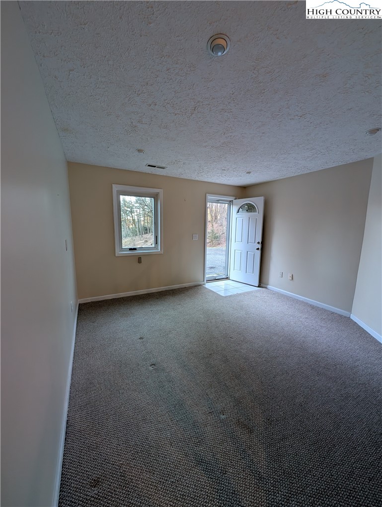 57 Village Road Glade Valley, NC 28627 - Photo 30 of 47 a view of a big room with windows and chandelier fan