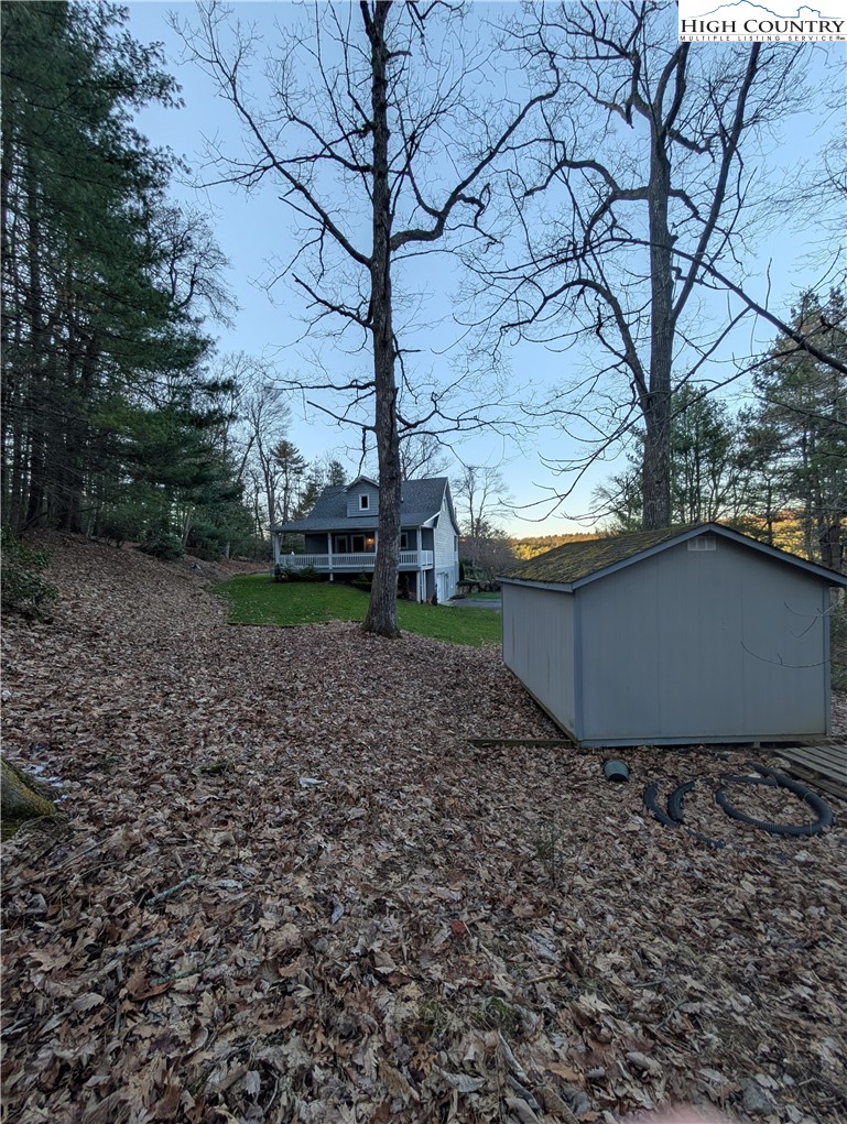57 Village Road Glade Valley, NC 28627 - Photo 37 of 47 a wooden bench sitting in middle of a backyard