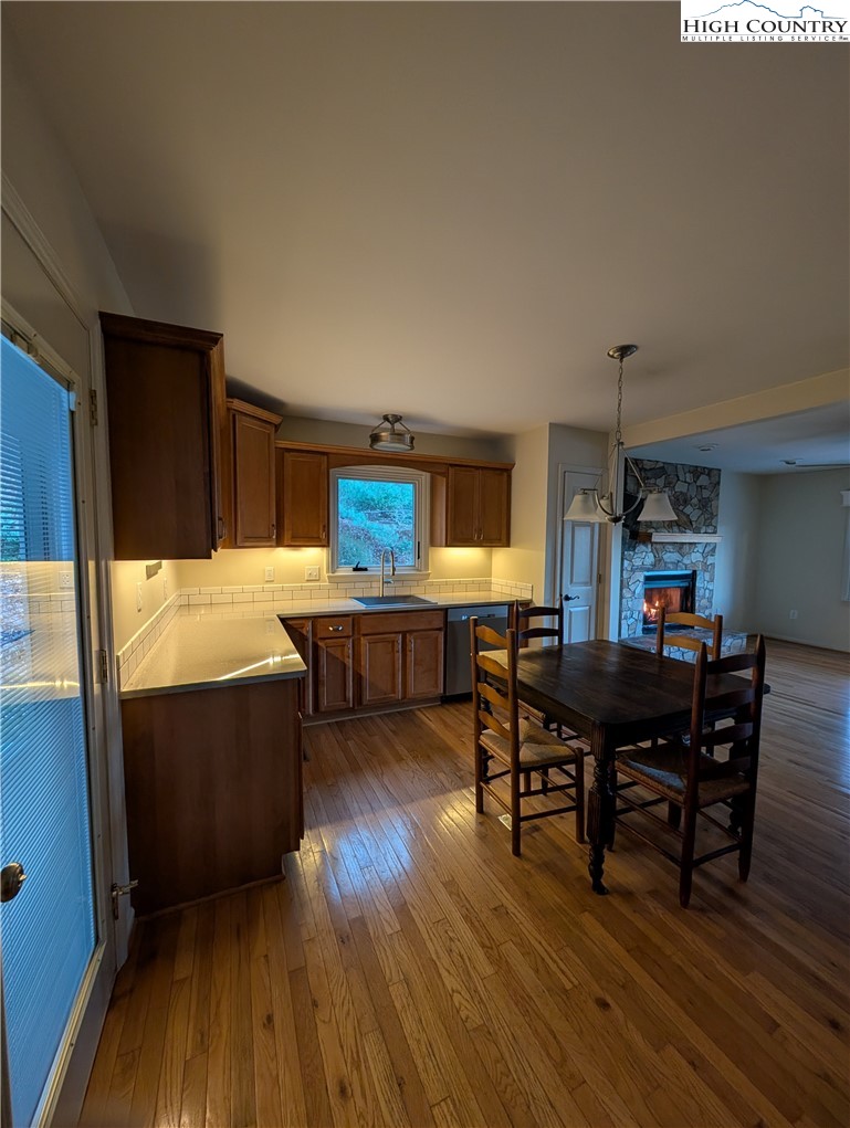 57 Village Road Glade Valley, NC 28627 - Photo 45 of 47 a living room with furniture and a dining table with wooden floor
