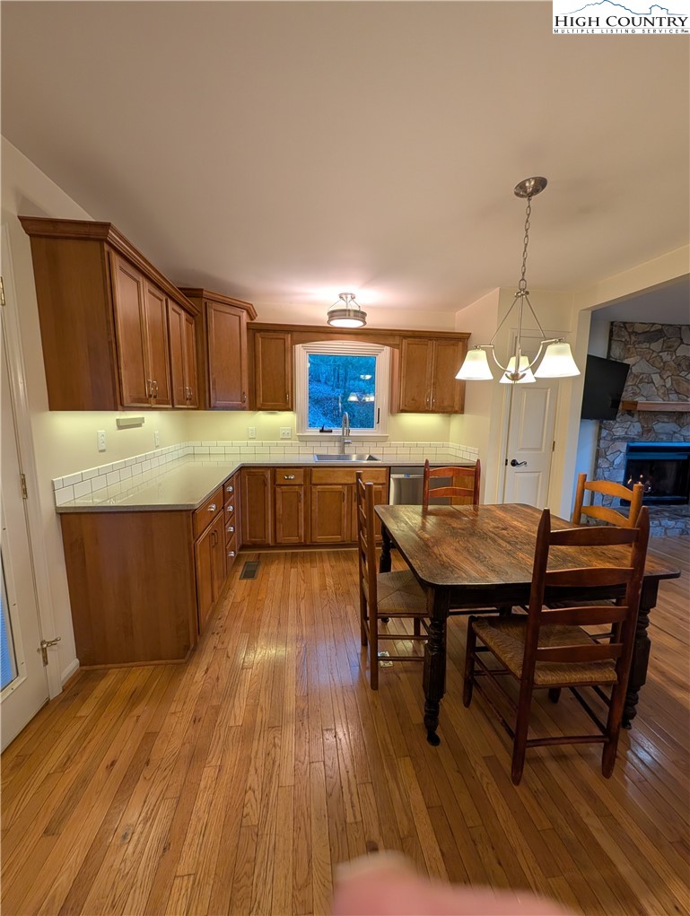 57 Village Road Glade Valley, NC 28627 - Photo 5 of 47 a kitchen with a table chairs a sink dishwasher window and cabinets