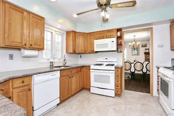 a kitchen with stainless steel appliances granite countertop a stove sink and cabinets